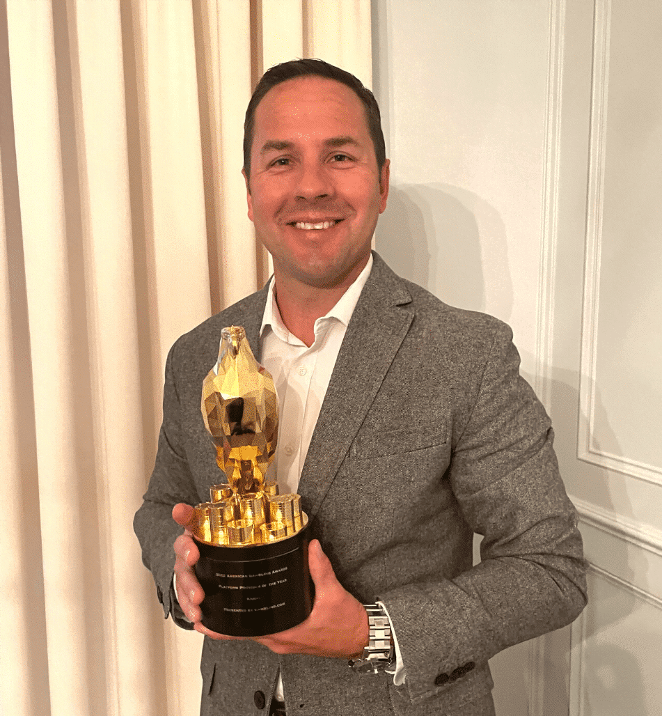 A photo of David Bretnitz holding a Platform Provider of the Year award.